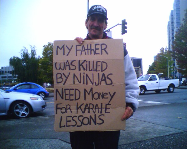 man-with-sign-need-karate-lessons